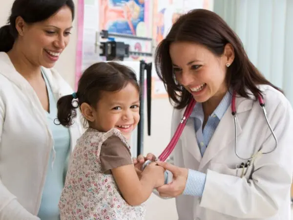 woman doctor with child patient and her parent