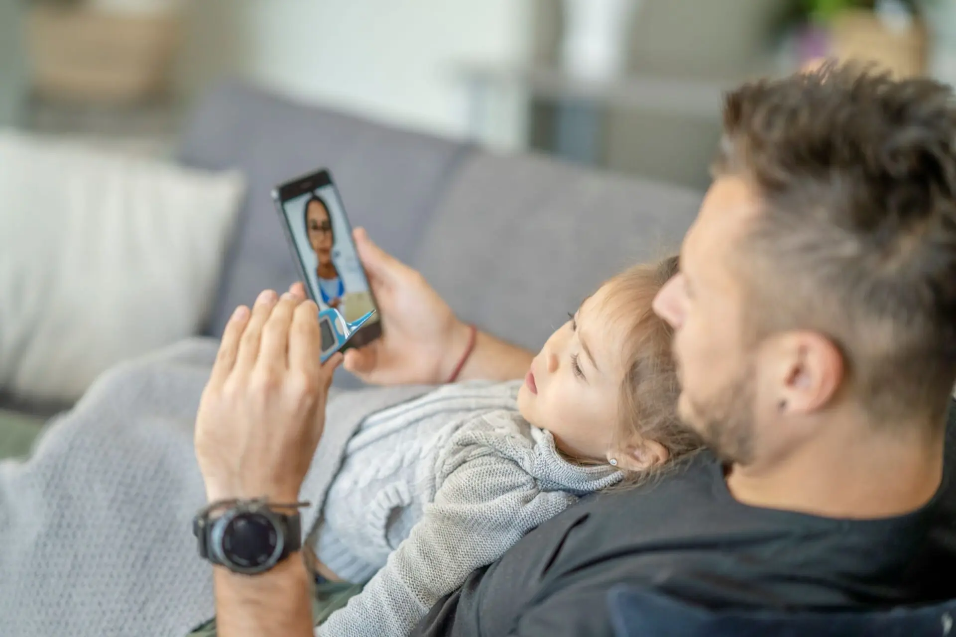 Man and child looking at cell phone