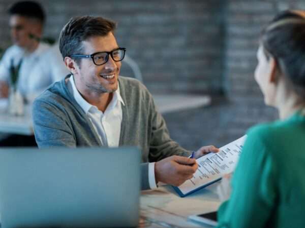 Happy businessman talking with his colleague