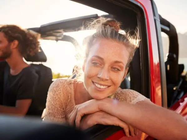 Man and woman in car on road trip