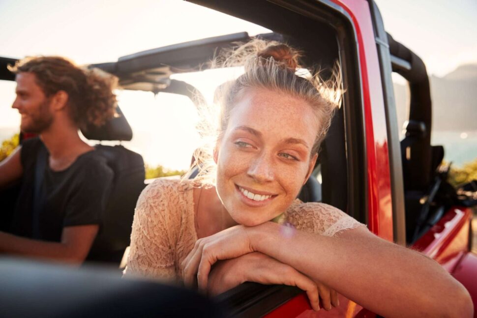 Man and woman in car on road trip