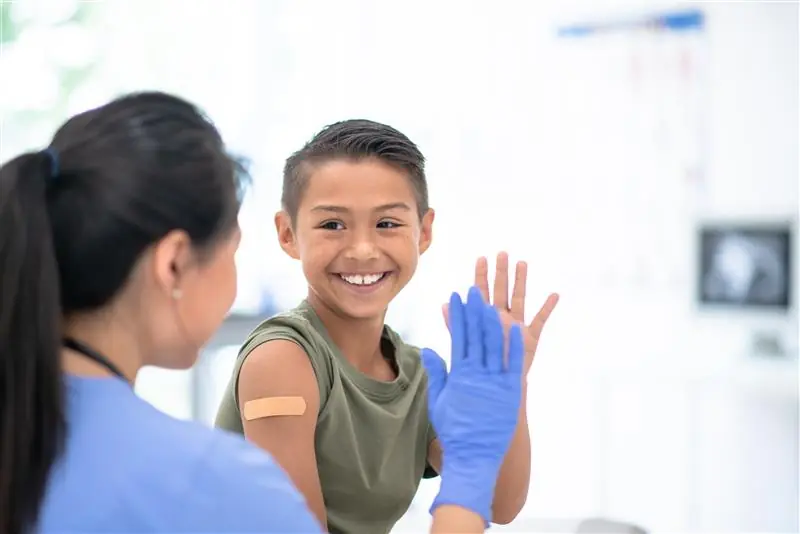 Boy and woman doctor high fiving