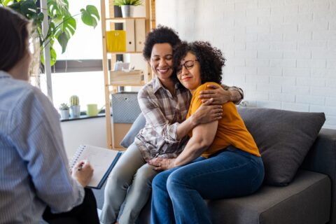 Two women hugging at doctor's office