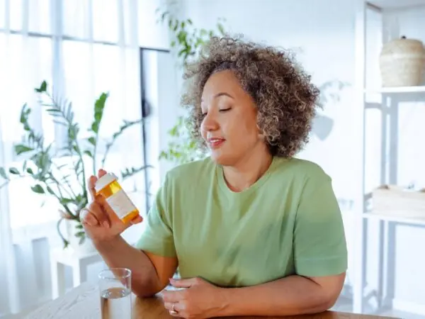 Woman reading pill bottle