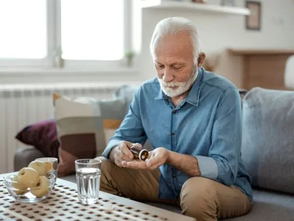 Senior male taking medication