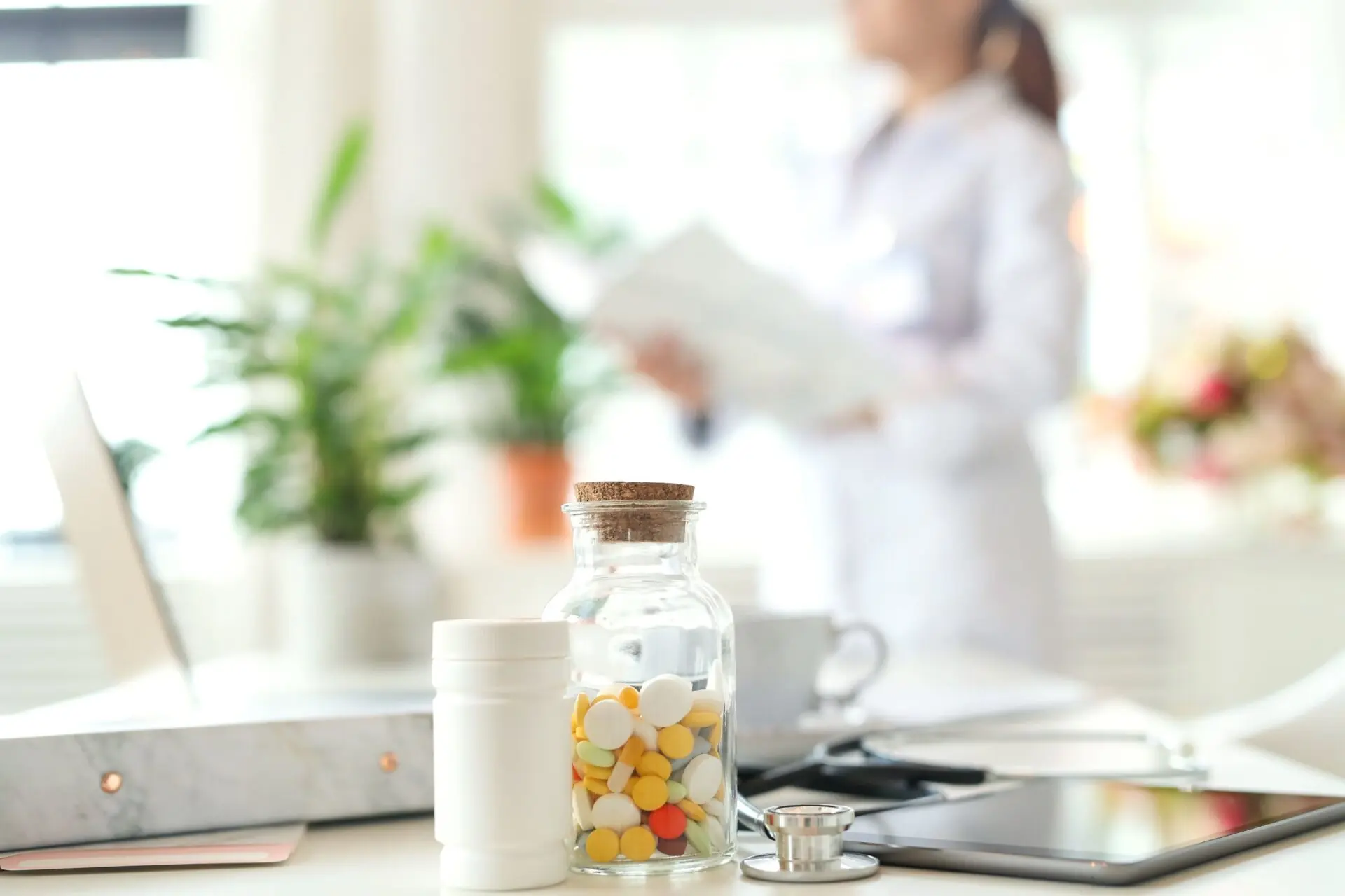 pill bottles on table with pharmacist in background