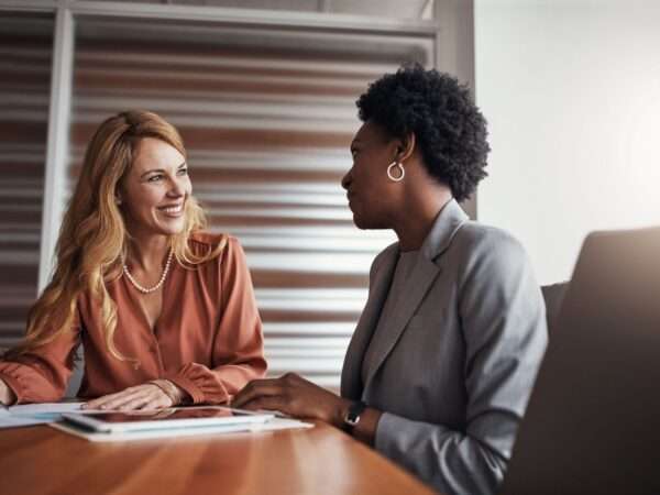 Two women at a conference table
