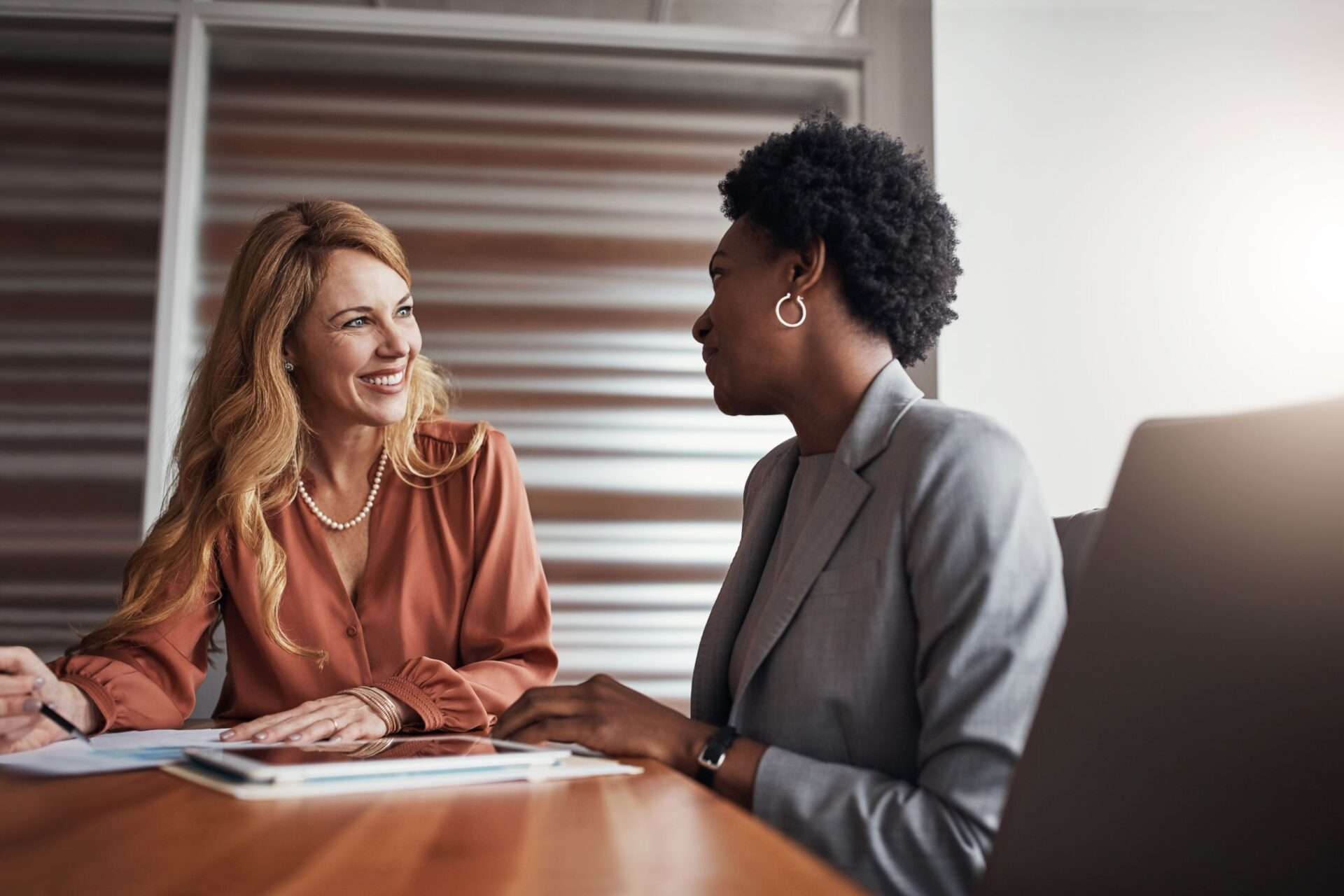Two women at a conference table