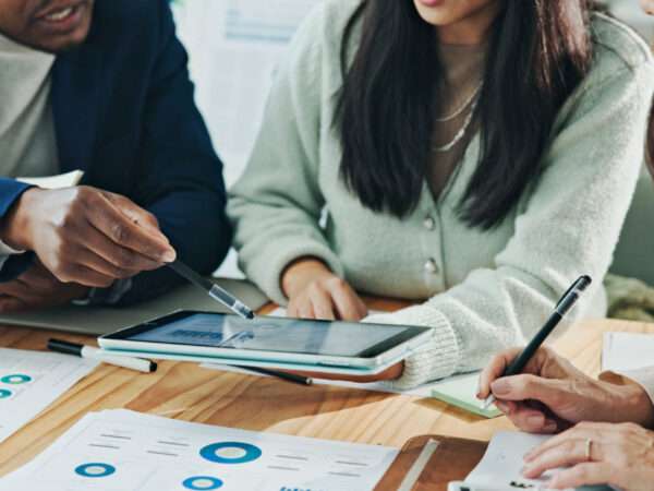 Business colleagues holding a tablet looking at reports