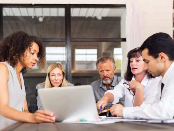 Business people around a laptop