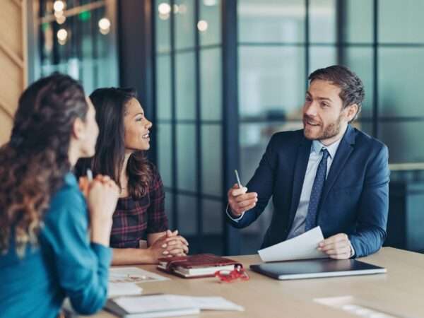 man and two women in a business meeting