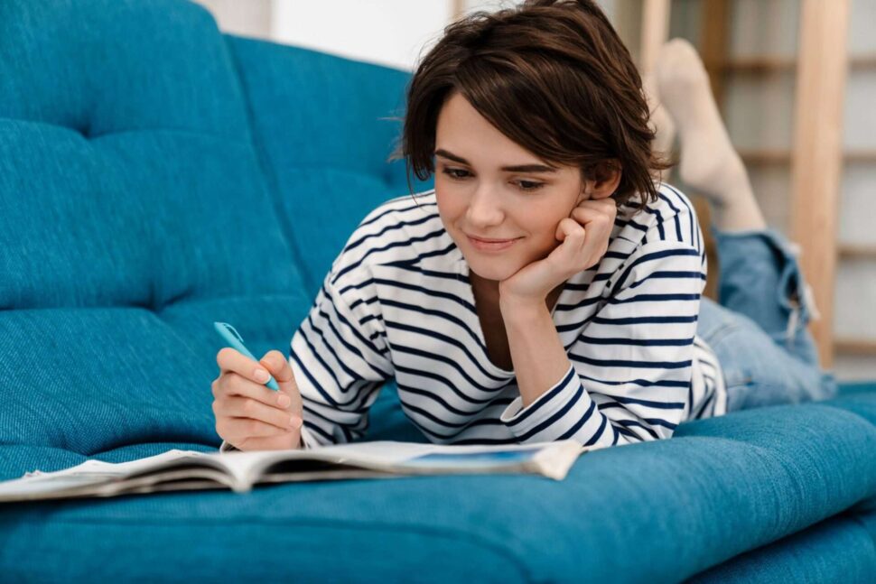 Woman doing homework on couch