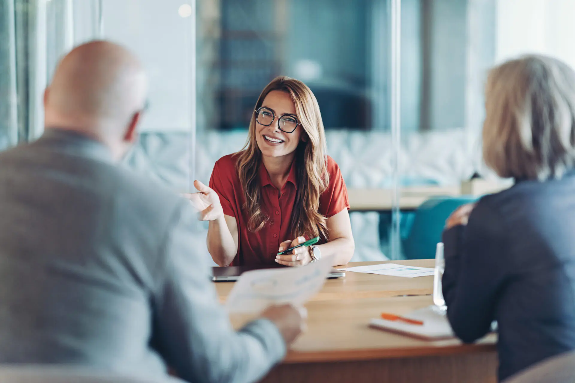 Young woman leader with glasses meeting with clients