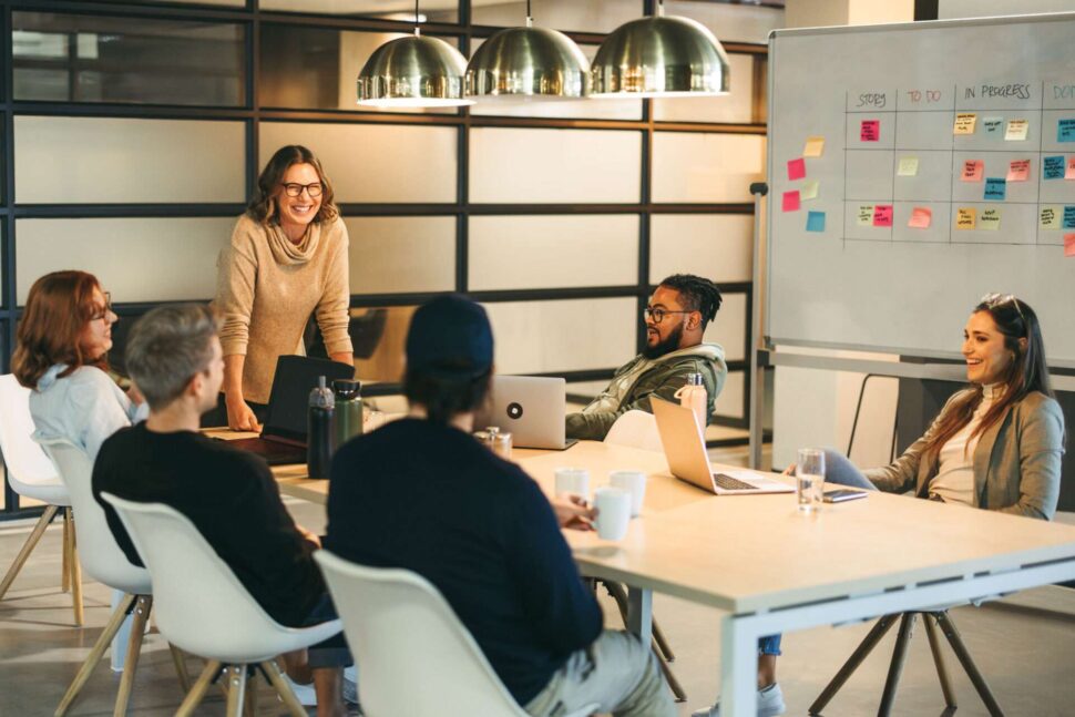 Colleagues at work around a white board