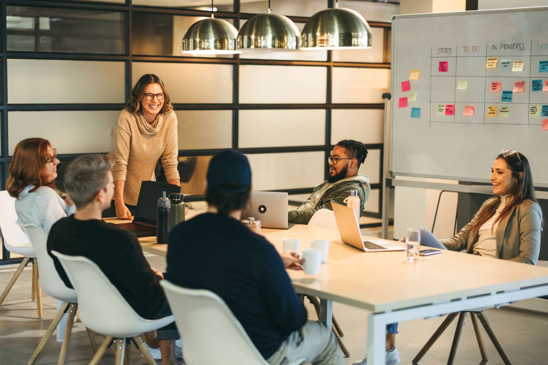 Colleagues at work around a white board