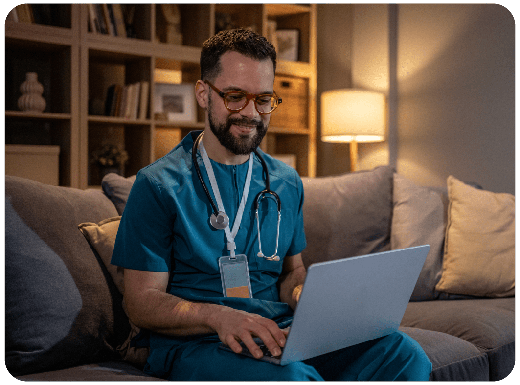 Doctor wearing glasses working on his laptop