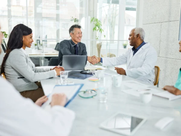 Doctors shaking hands at hospital meeting